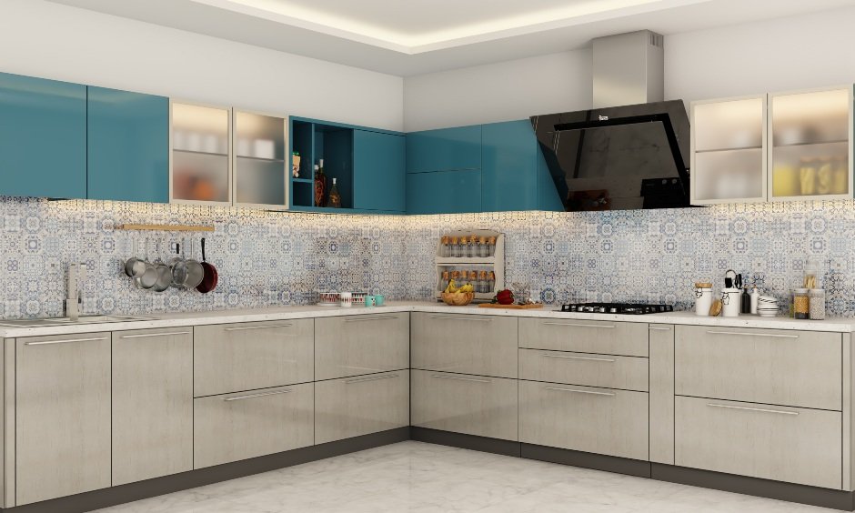 Modern L-shaped kitchen with blue and beige cabinets, patterned tile backsplash, built-in stove, and under-cabinet lighting.