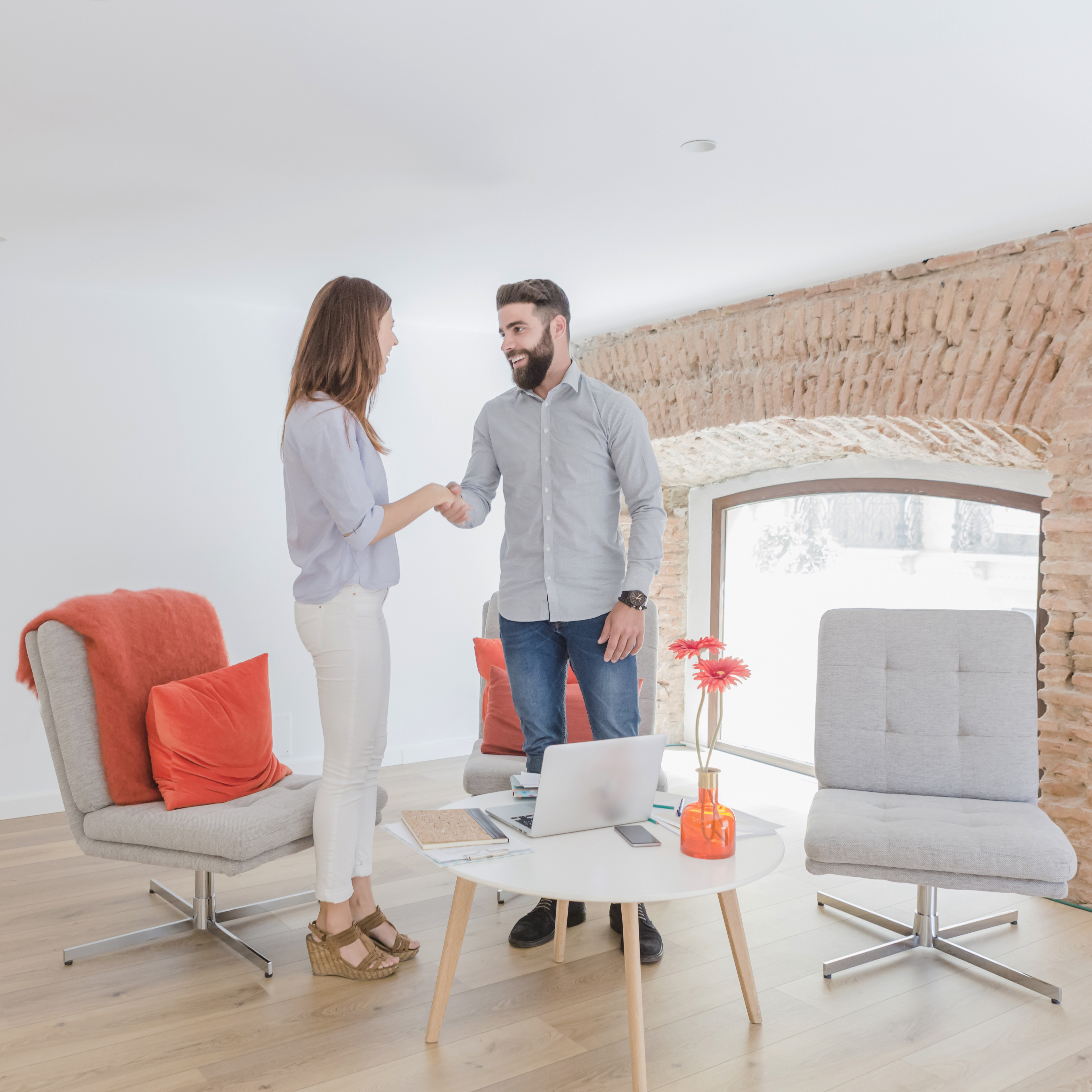 Modern L-shaped kitchen with blue and beige cabinets, patterned tile backsplash, built-in stove, and under-cabinet lighting.