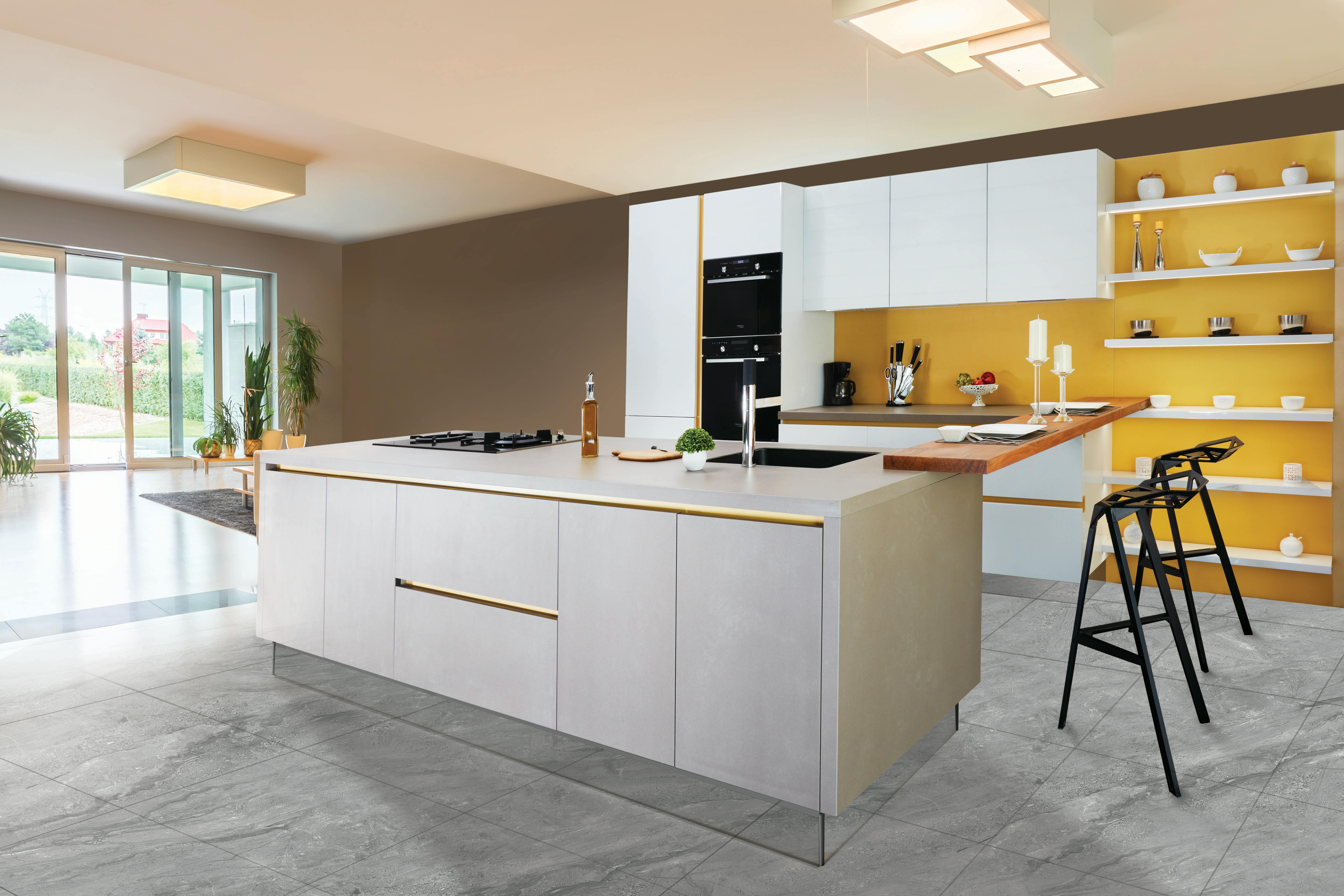 Open concept kitchen with large gray island, bright yellow accent wall, and white cabinets