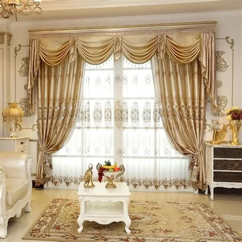 Luxurious gold satin curtains with ornate embroidery and matching valances in an elegant, classic living room setting.
