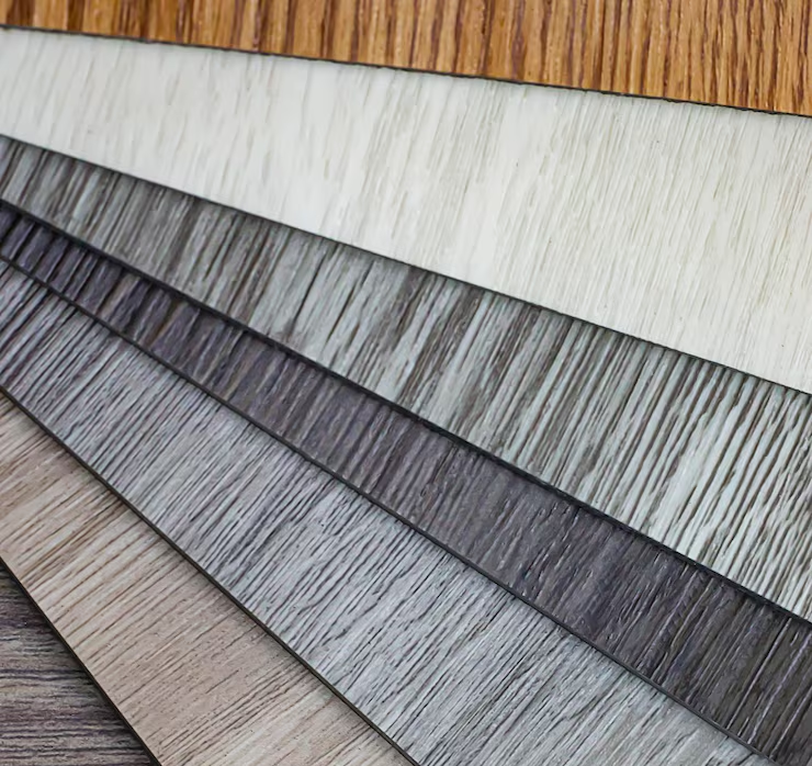 Modern living room interior with warm peach and white marble walls, an orange armchair, indoor green plants, and large windows allowing 
                       natural sunlight to fill the space.